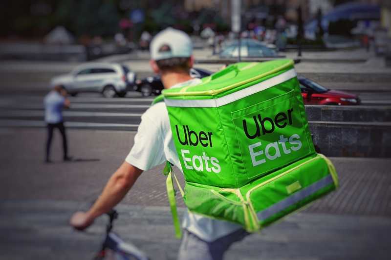 A very green food delivery backpack