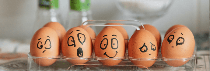 6 eggs with different funny faces drawn on them